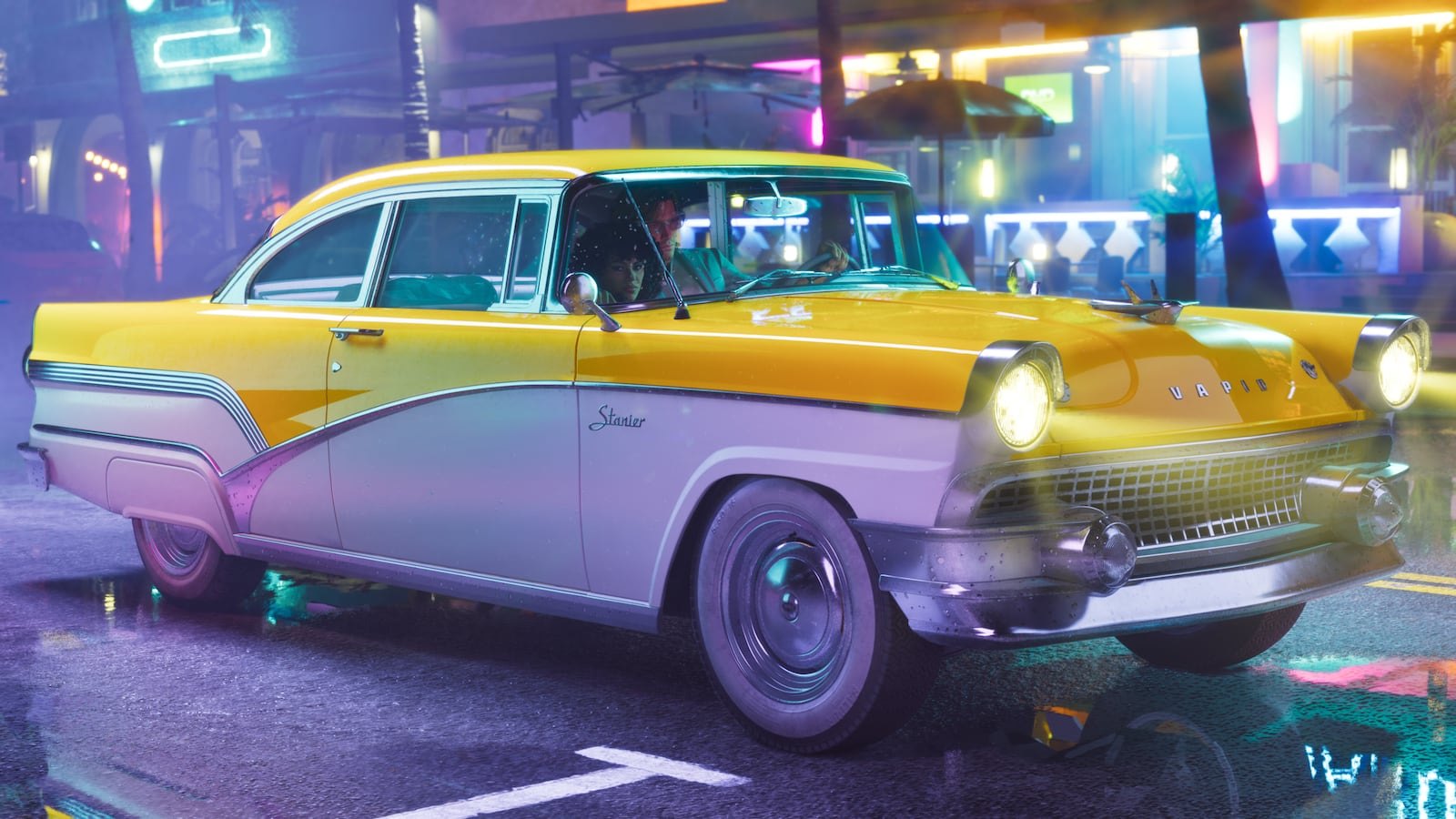 A yellow and white vintage Ubermacht Stanier classic car driving through a neon-lit city street at night.