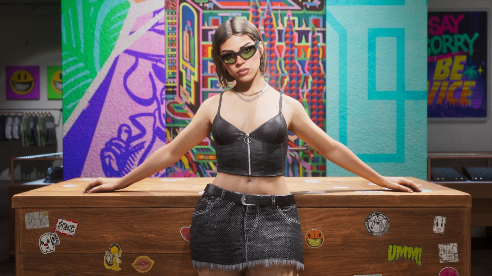A young woman in a black crop top and denim skirt stands behind a wooden counter inside a colorful street-art-decorated shop.
