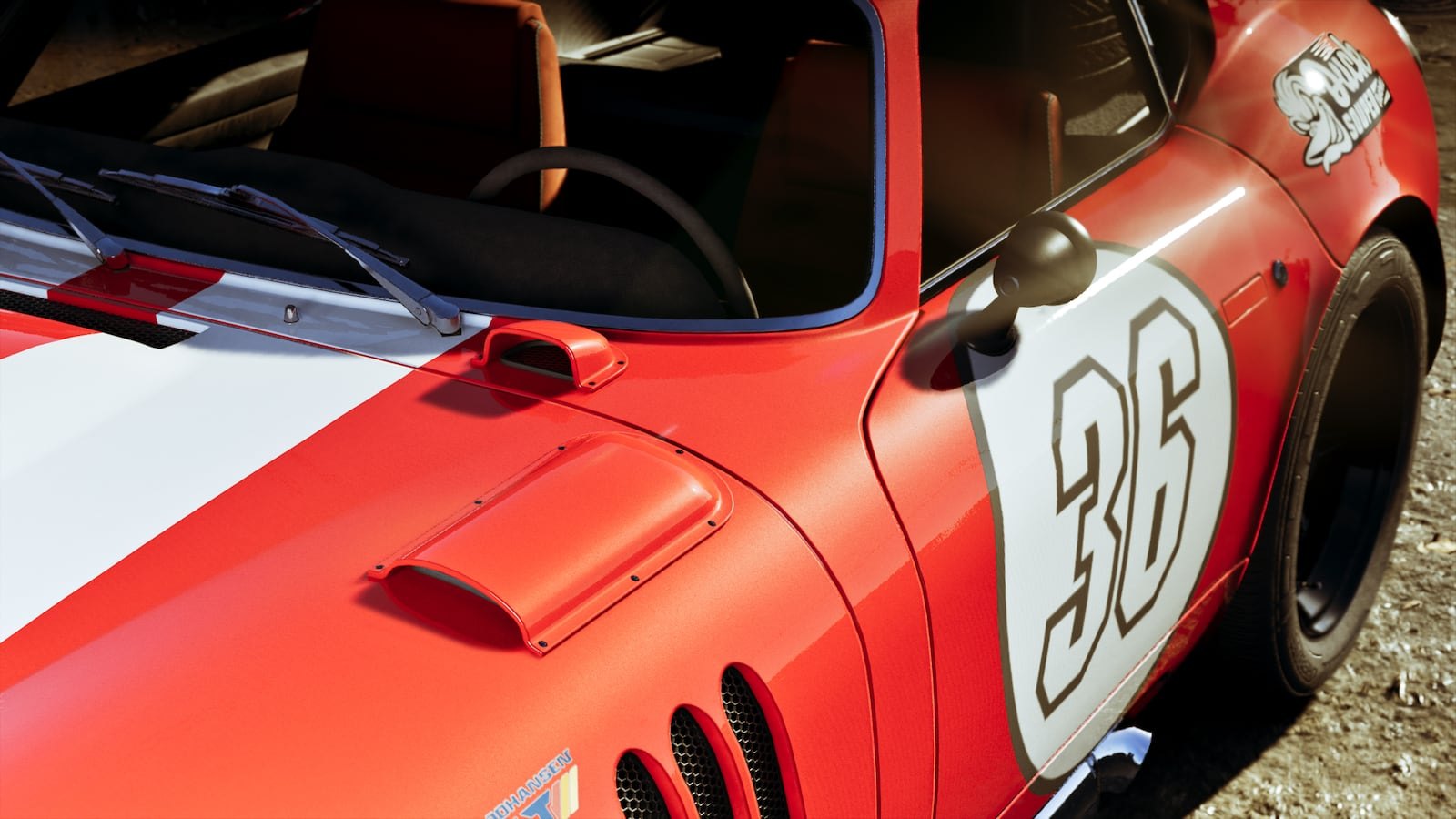 Close-up front three-quarter view of a red classic sports car numbered 36 with white racing stripes.