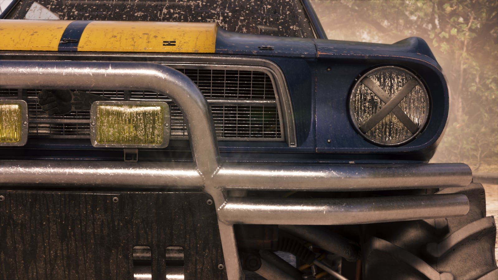 Close-up of the front end of a blue and yellow off-road muscle car showing a roll cage bumper, auxiliary lights, and taped-over headlights.