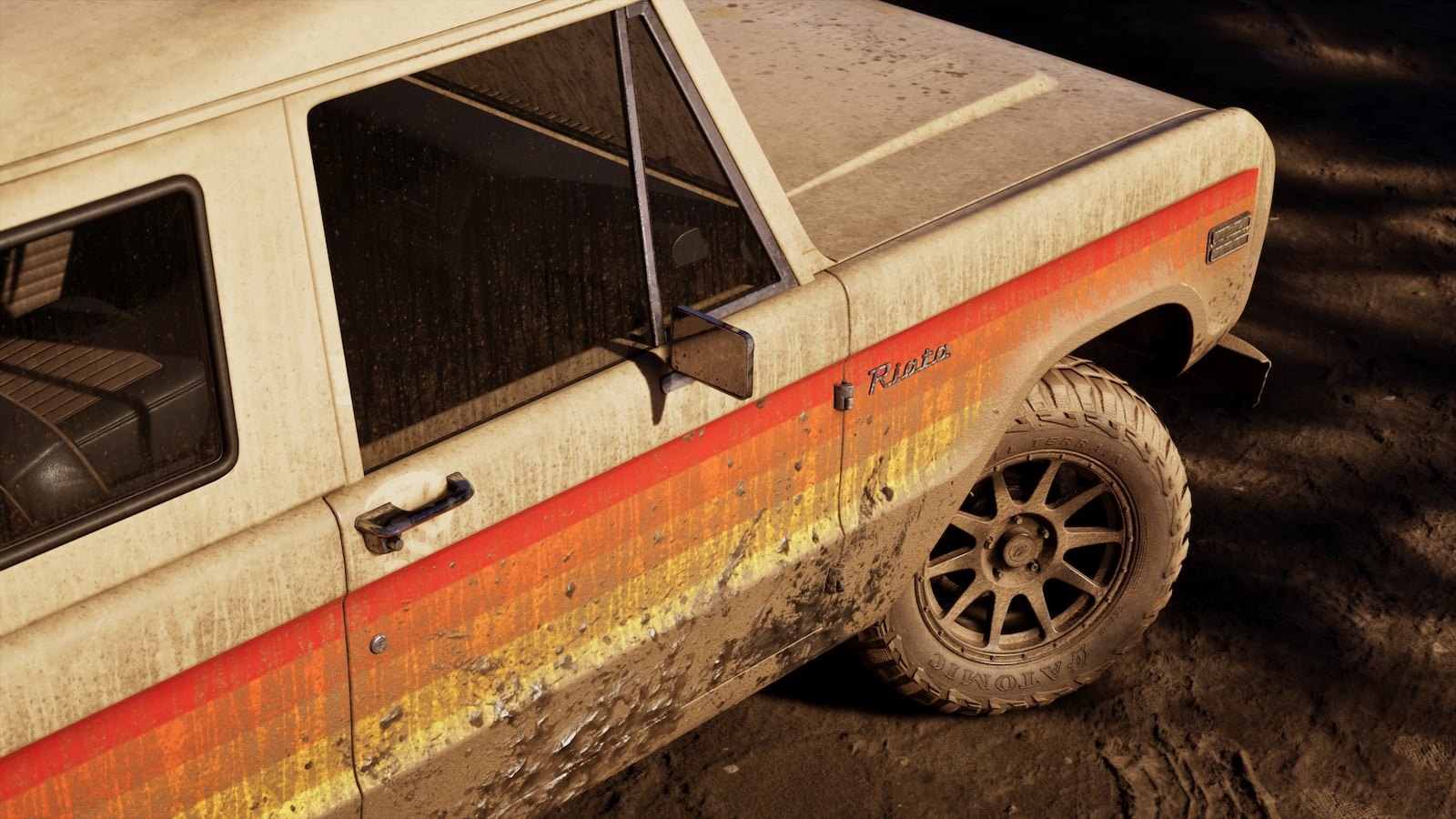 Close-up side view of a mud-covered beige vintage off-road truck with orange and red stripes, badged 'Ranger'.