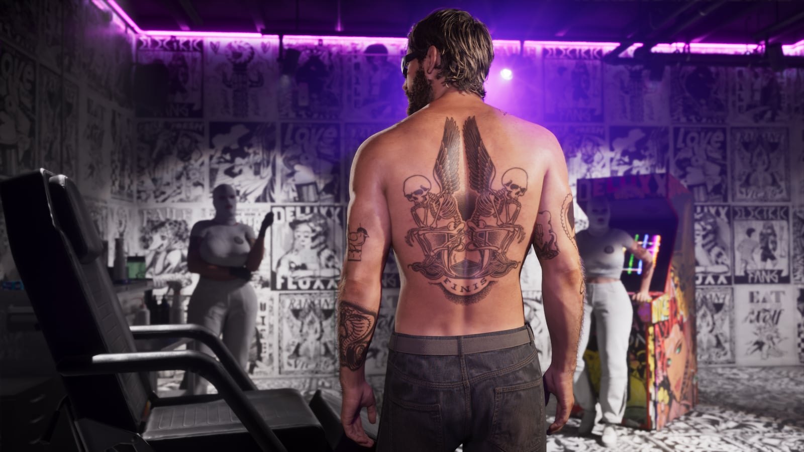 A shirtless tattooed man with a large back tattoo stands inside a room decorated with black and white posters under purple lighting.