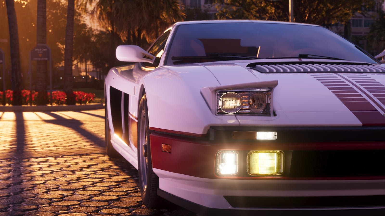 Close-up front view of a white and red supercar with its headlights on in golden hour light.