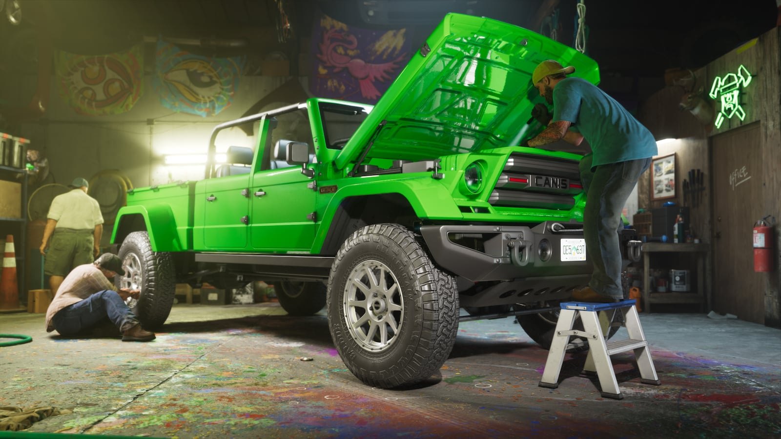 A bright green Canis truck with its hood open being worked on by two mechanics inside a graffiti-covered garage.